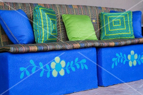 Bright blue bench with decorative throw pillows and cushions ? Bild kaufen ? living4media