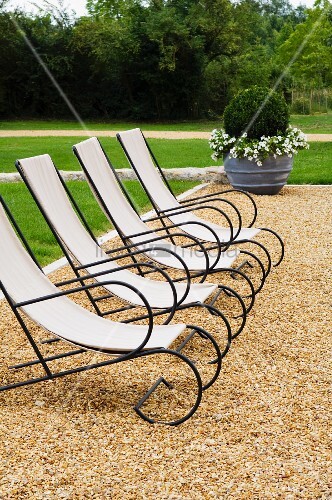 Elegante Liegestühle mit schwarzem Metallgestell und Segeltuch auf