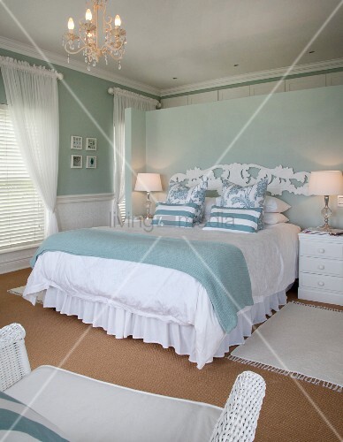 White Bed Linen And Pastel Blue Bedspread On Double Bed With