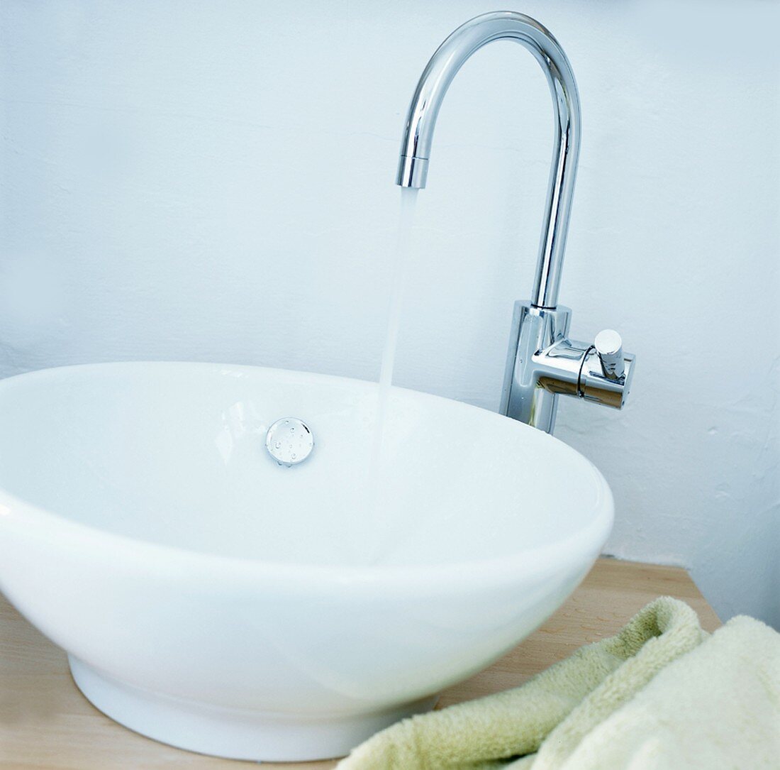 A wash basin with running tap