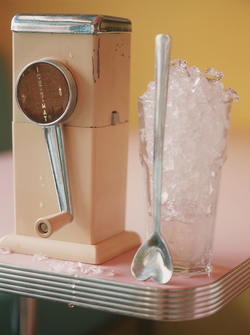An ice crusher with a glass full of ice