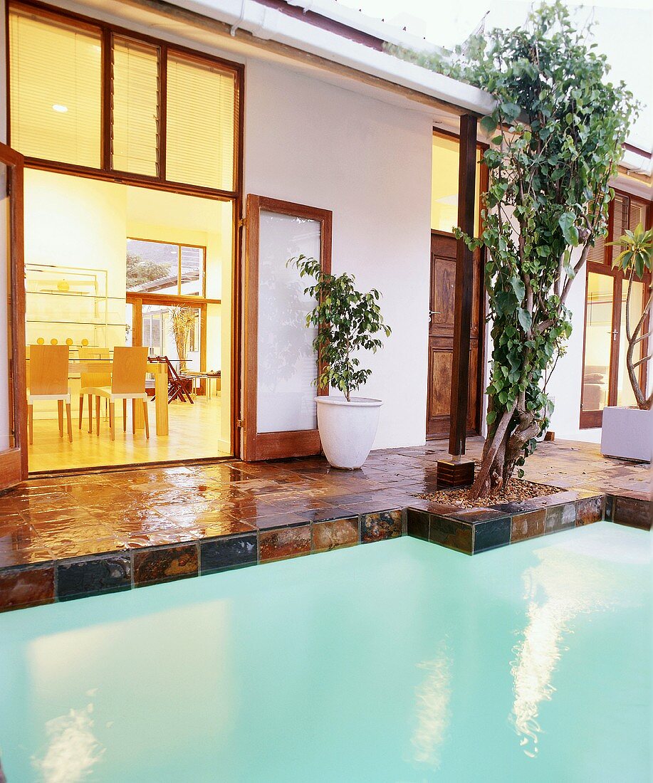 Glossy floor tiles framing turquoise water in pool