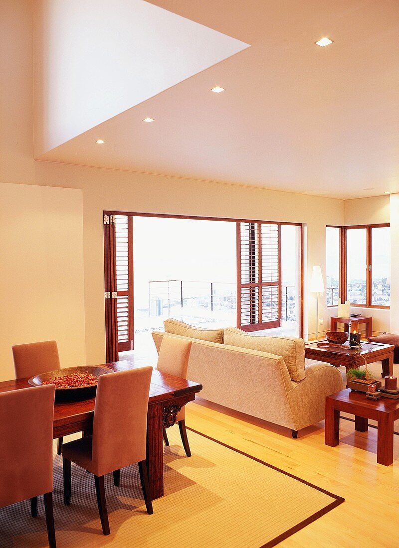 Cheerful interior with dining and living area and open terrace doors leading to terrace