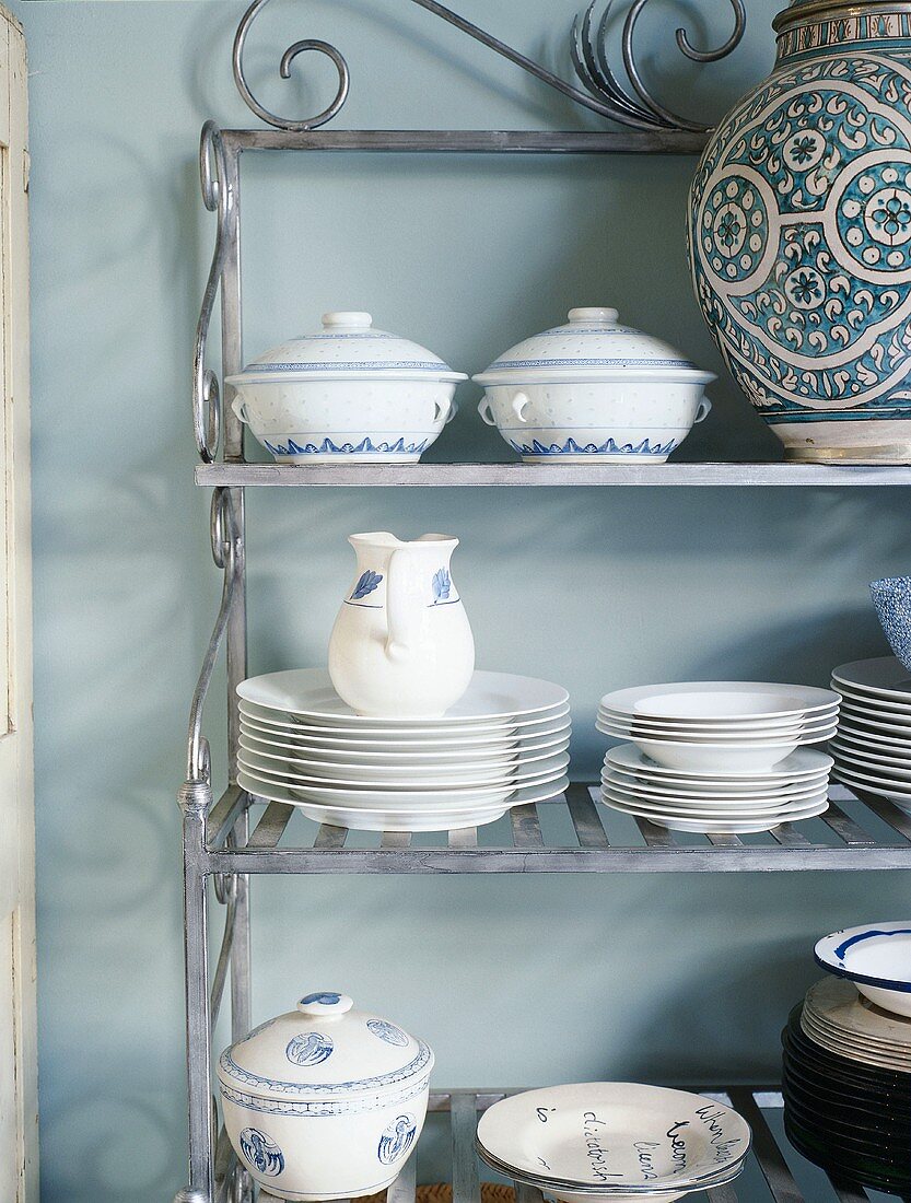 White and blue crockery on metal shelves