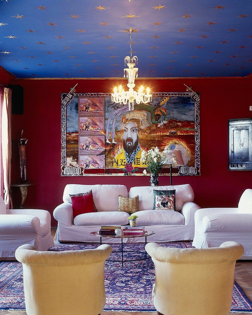 Living room with white sofa combination, large wall hanging with Chinese motif, gilt stars on ceiling and Chinese silk rug