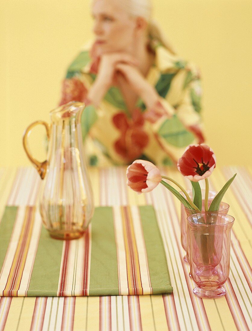 Tulips on table with woman in background
