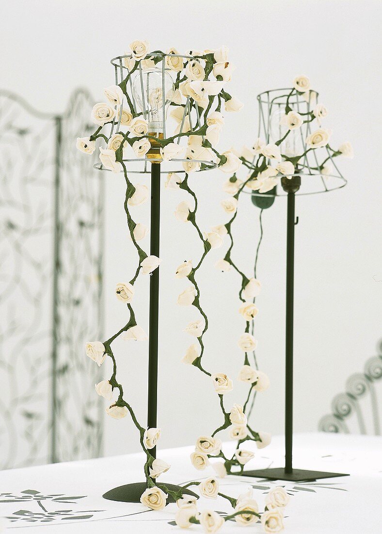 Flowers hanging from table lamps