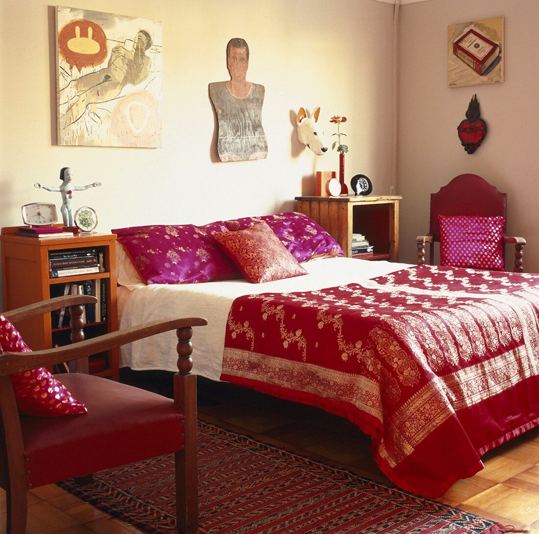 Bunte Satinbettwäsche und viel Dekoration bilden im Schlafzimmer einen poppigen Stilmix