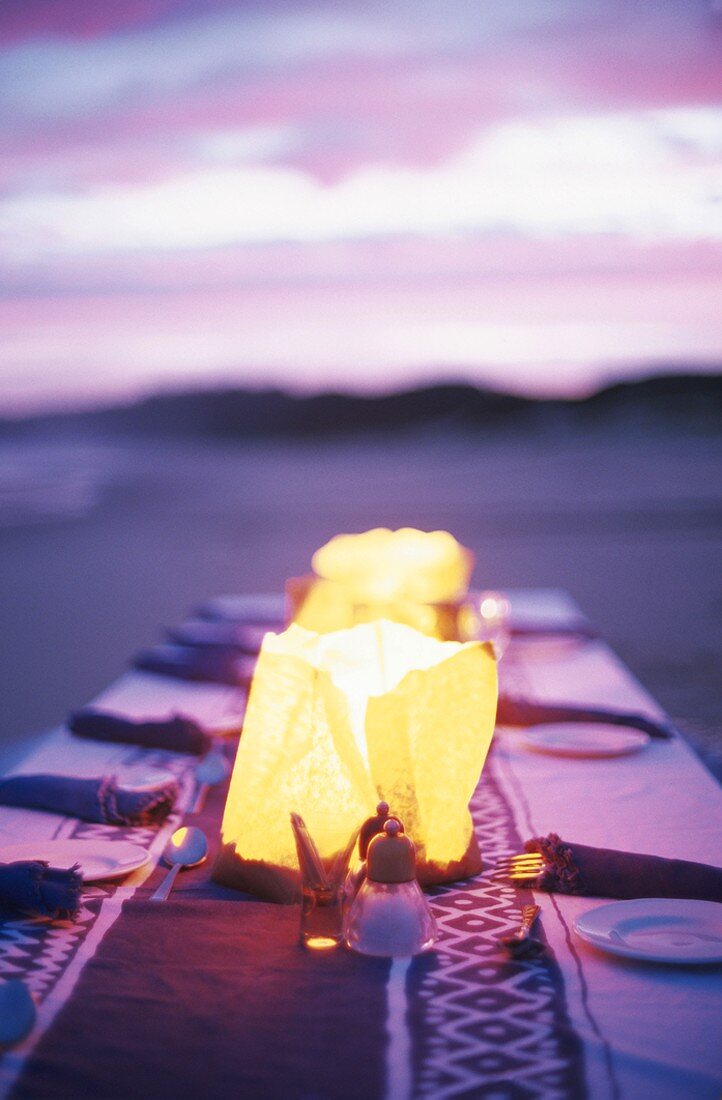 Set table on beach at twilight