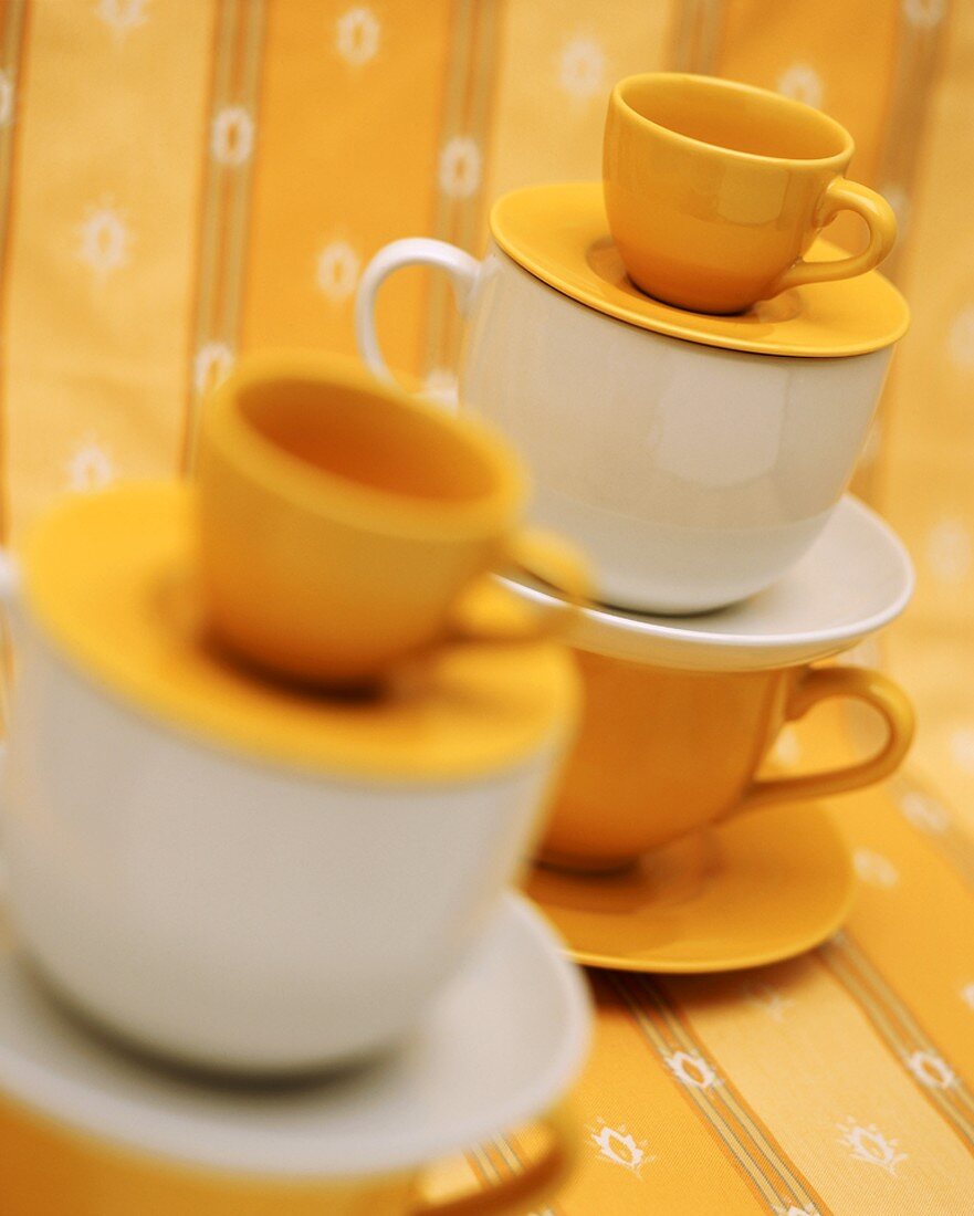 Yellow and white cups and saucers
