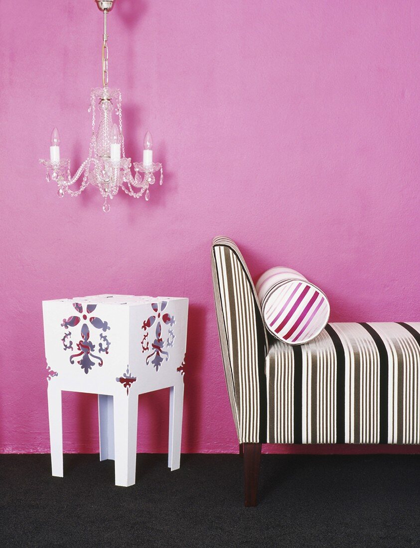 Chaise longue against pink wall