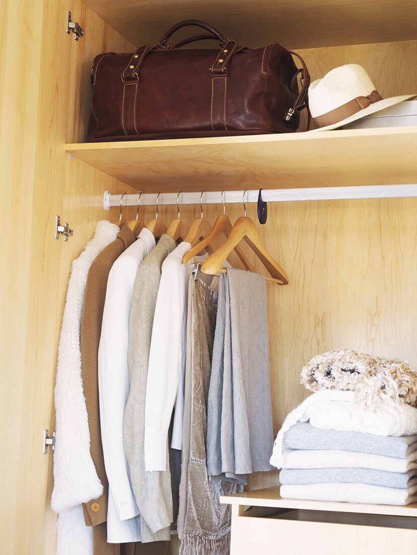 Kleidung und Wäsche im Schrank hängend