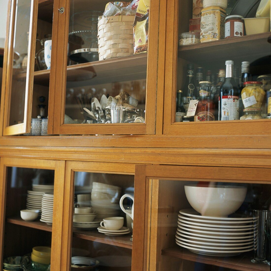 Crockery and groceries in kitchen cupboard