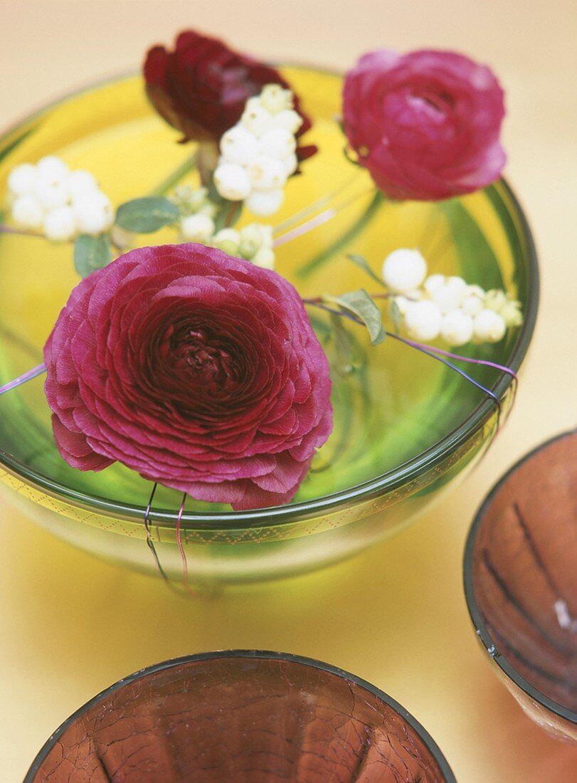 Flowers floating in glass dish
