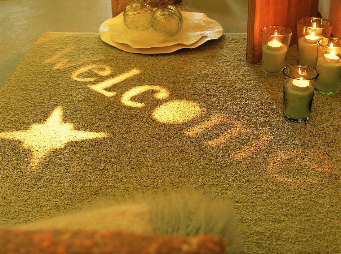 Candles and lights shining on rug