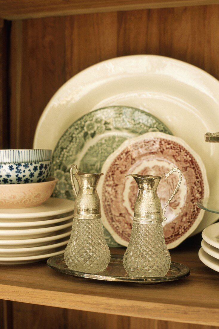 Pair of crystal jugs in cupboard