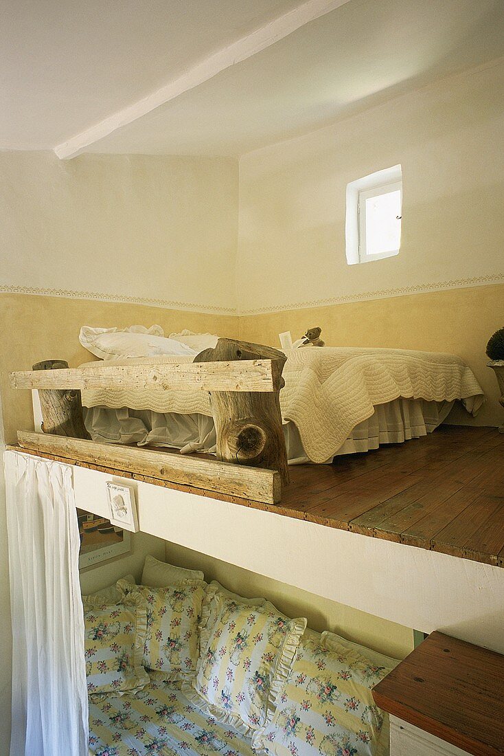 A bed on a sleeping gallery under a roof