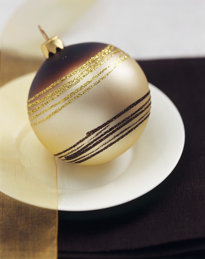 A brown and gold Christmas bauble (table decoration)