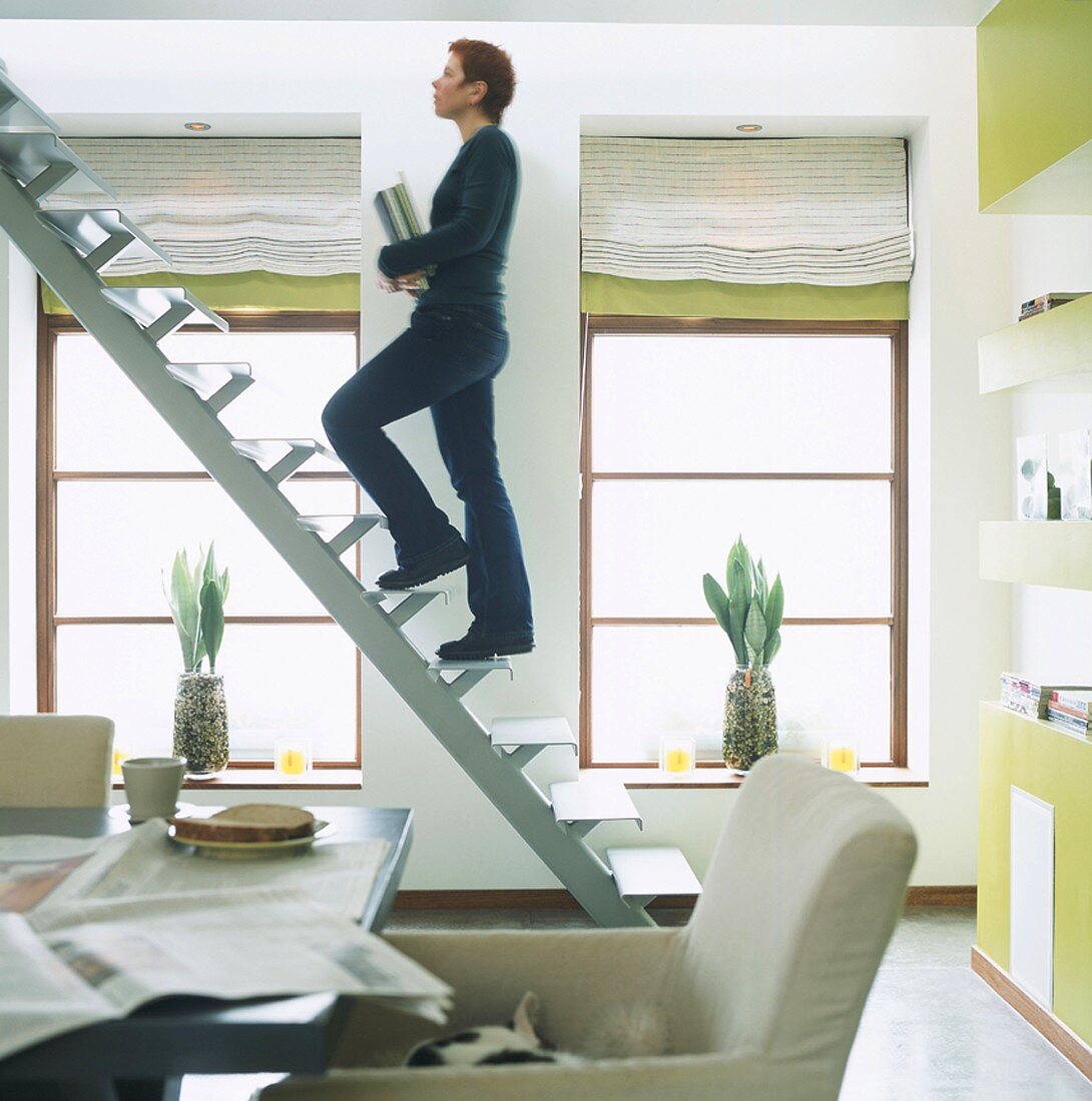 Woman walking up staircase without handrails