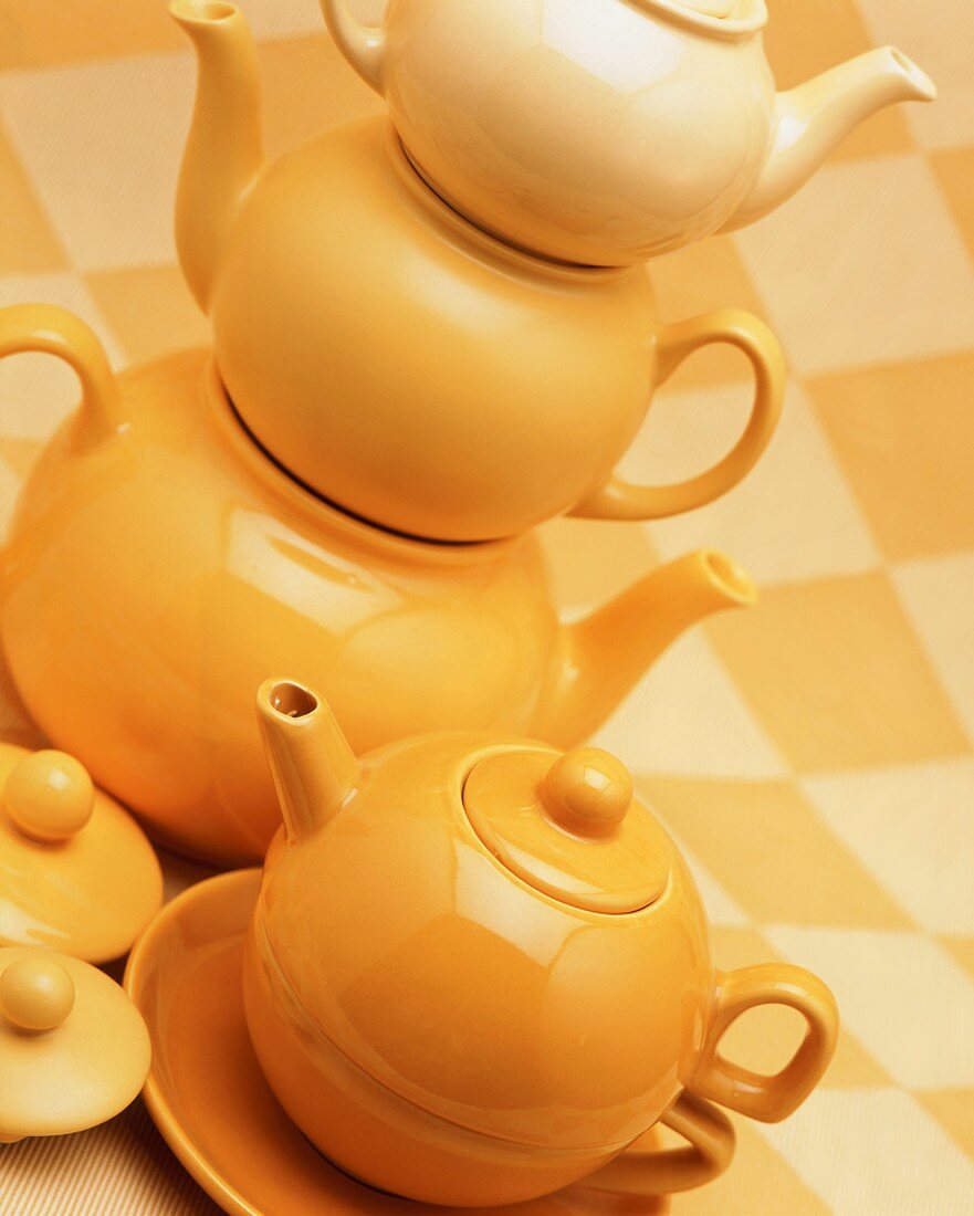 A stack of yellow teapots