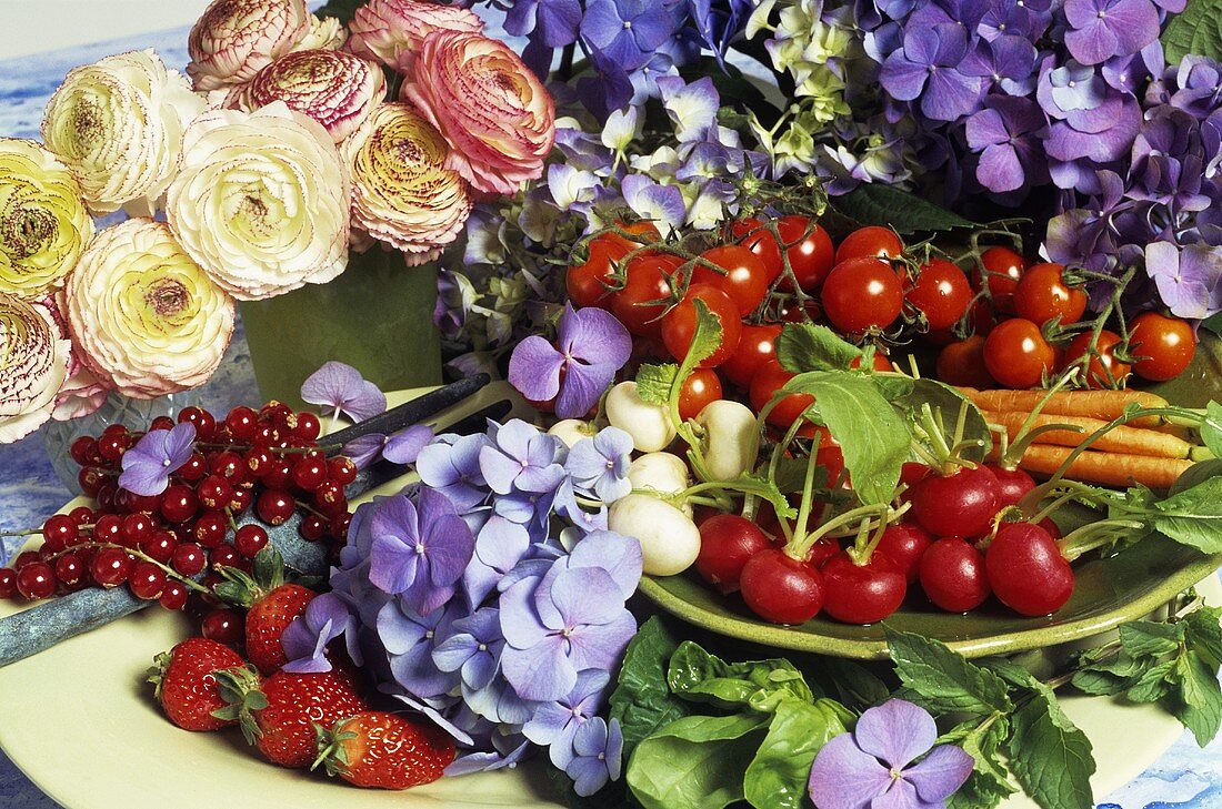 Still life of summer fruit, vegetables and flowers