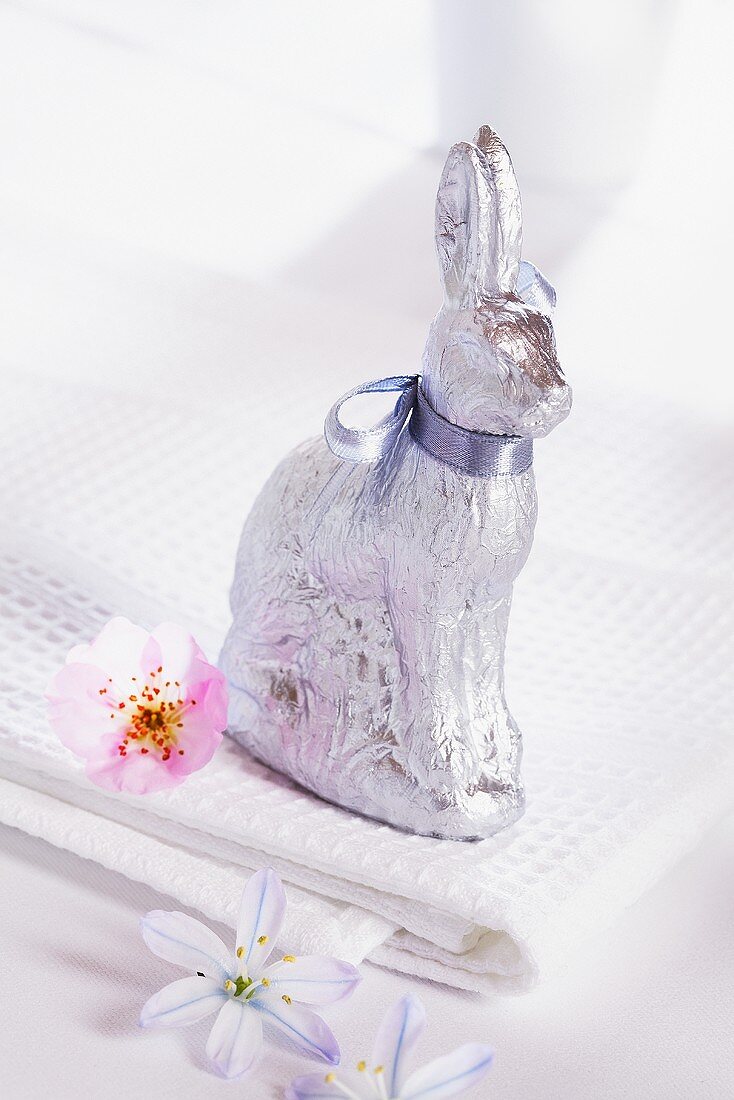 A chocolate bunny wrapped in silver paper