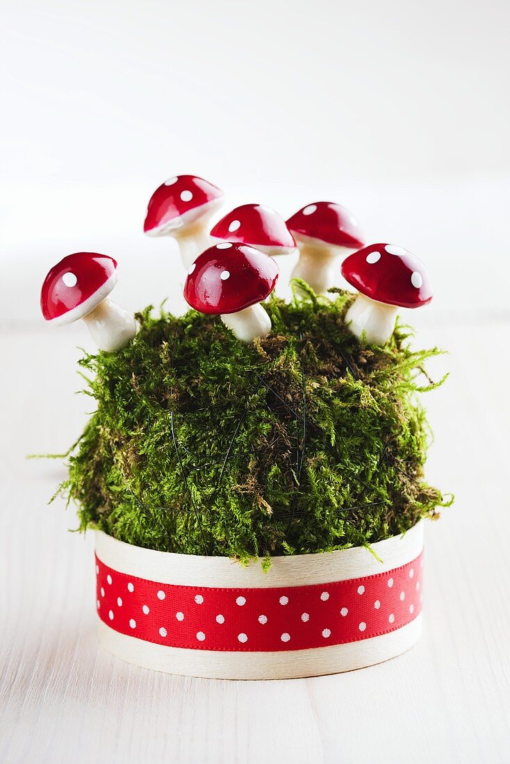 New Year's decoration with moss and decorative toadstools