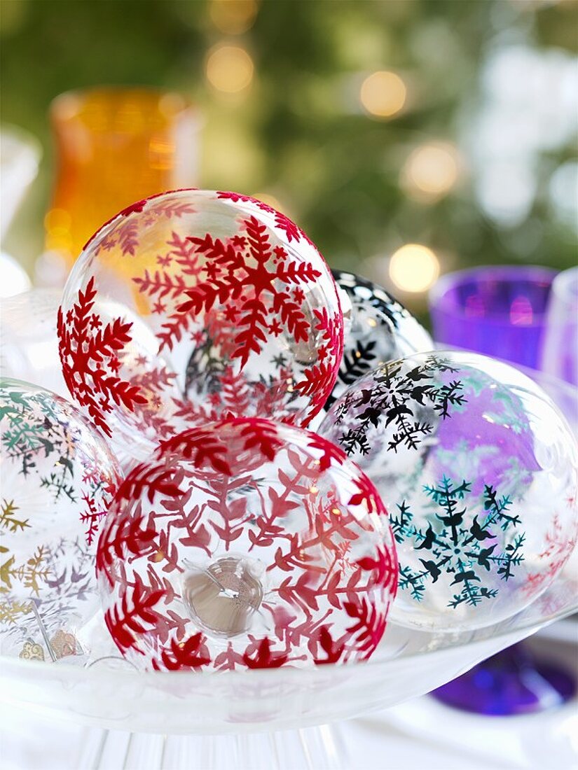 Bemalte Weihnachtskugeln in einer Glasschale