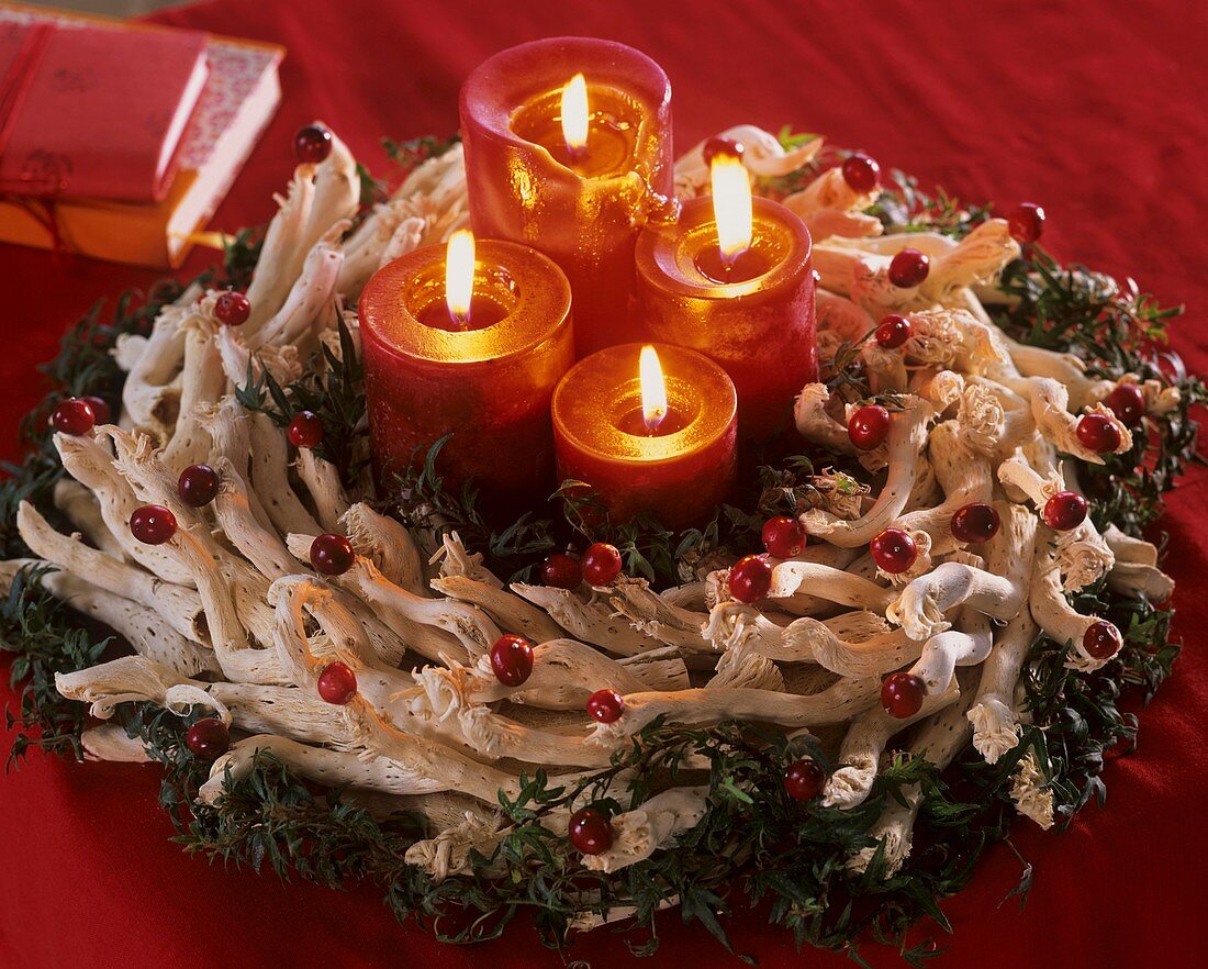 Advent wreath of twigs, ivy and cranberries with candles