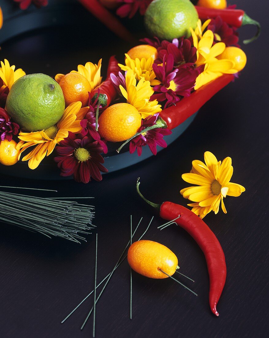 Arrangement of flowers and citrus fruit