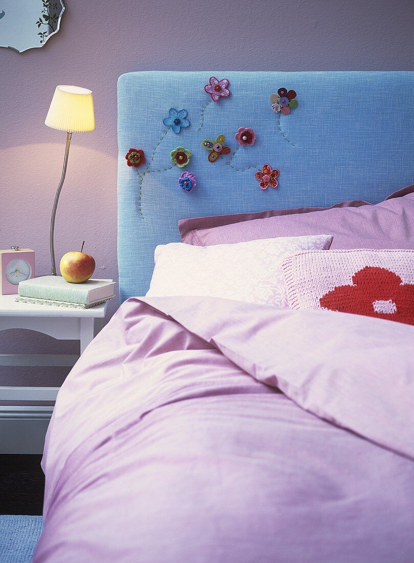 Bed with embroidered headboard