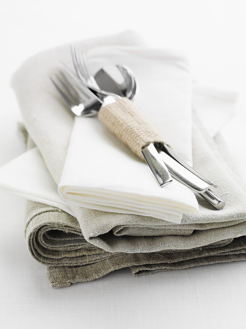 Cutlery on a pile of linen cloths