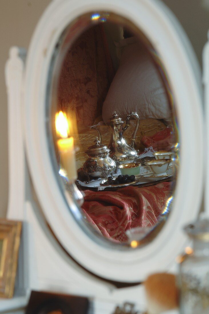 Breakfast tray reflected in bedroom mirror