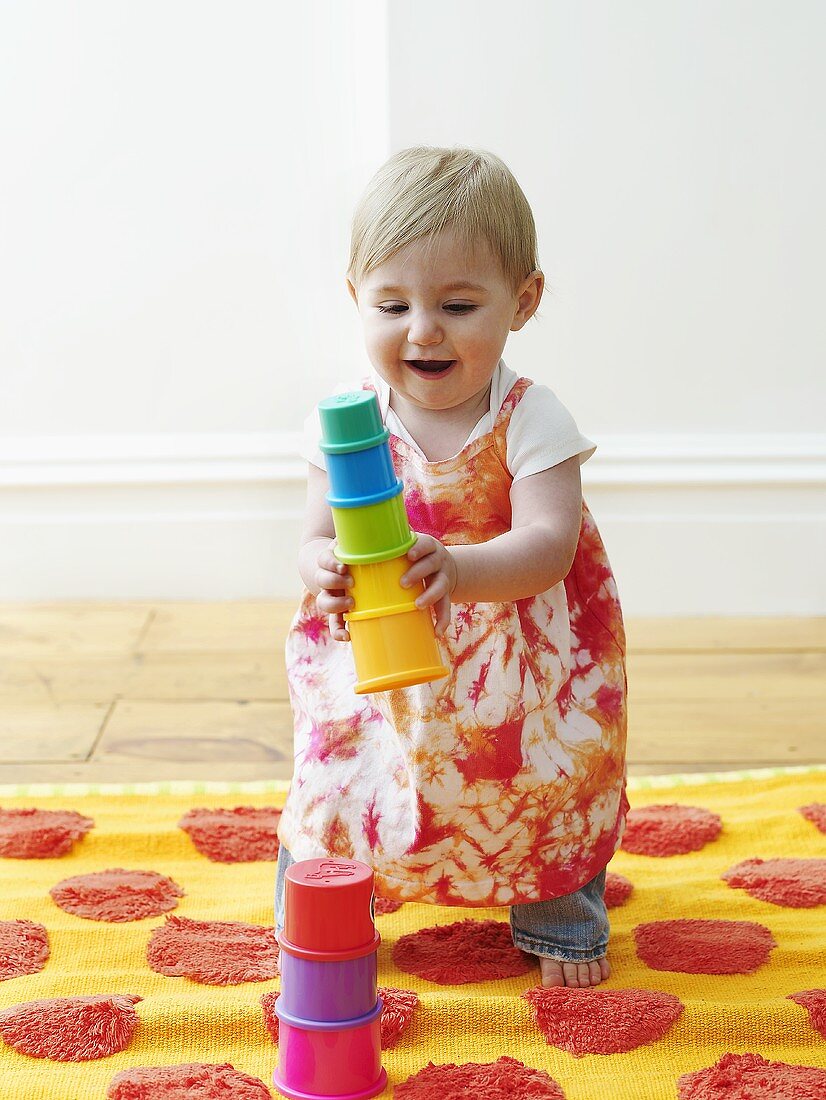 Little girl playing with plastic shapes