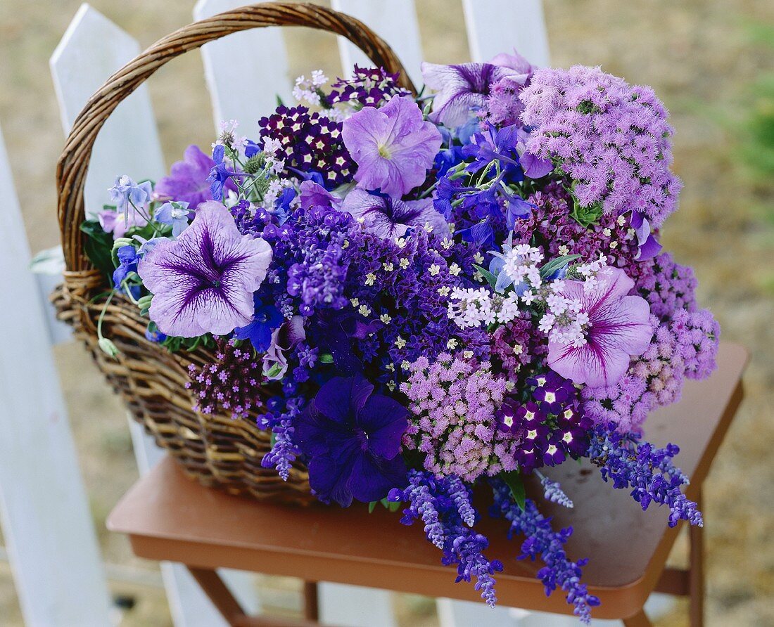 Purple cut flowers in a wicker basket