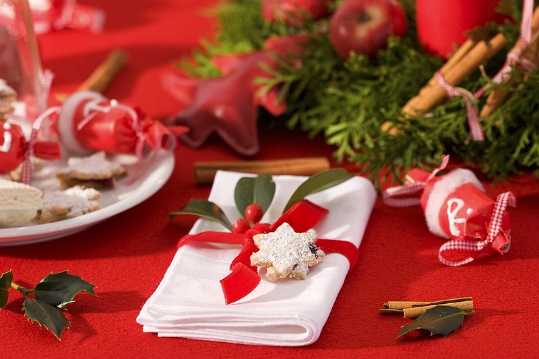 Napkin with holly and nut star on Christmas table
