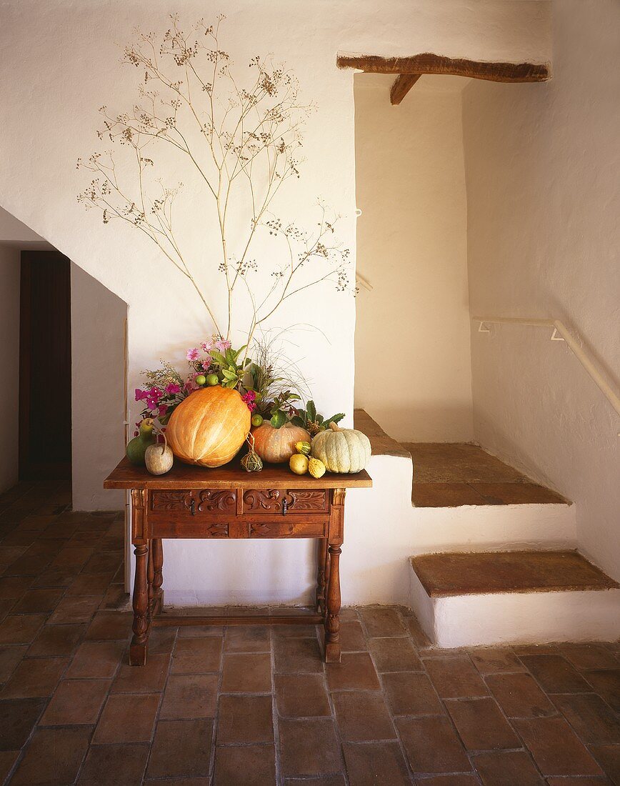 Small table with arrangement of pumpkins