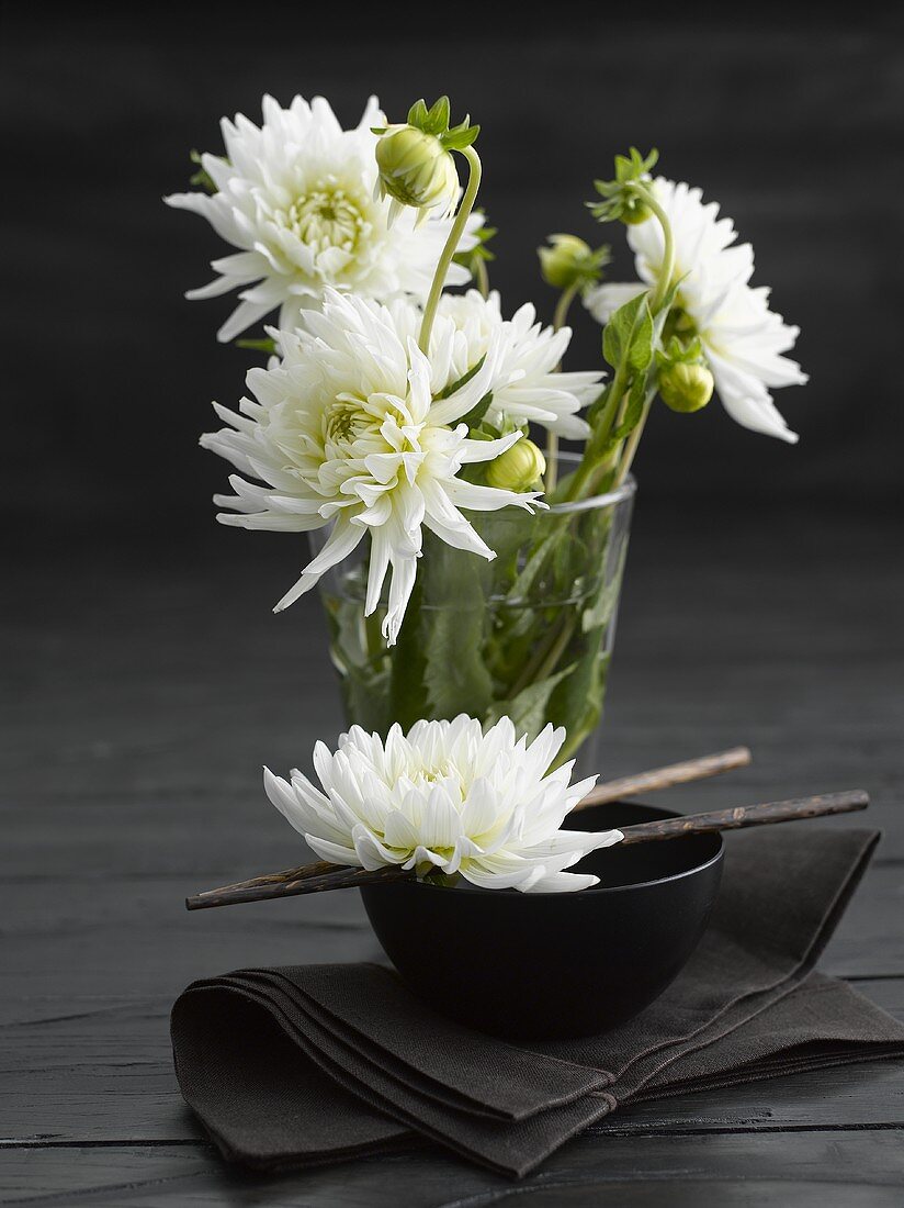 Asian place-setting with white chrysanthemums, dark background