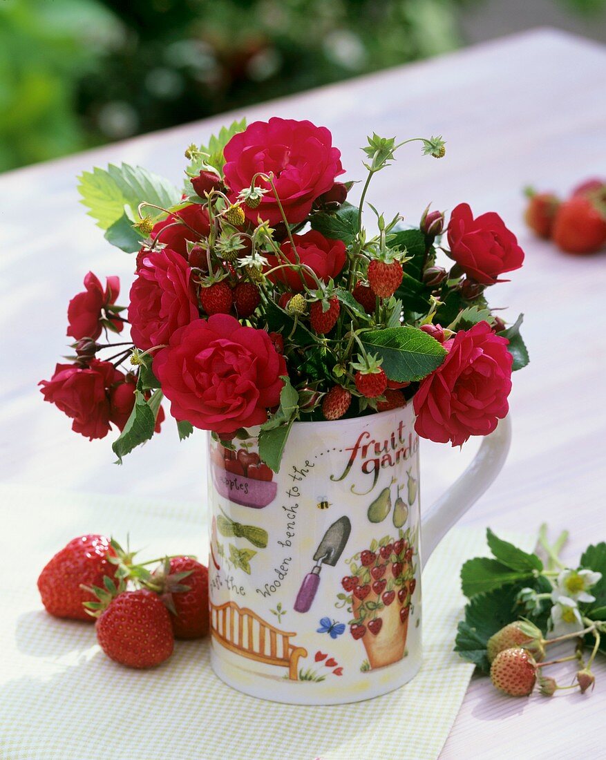 Kleiner Strauss aus roten Rosen und Erdbeeren