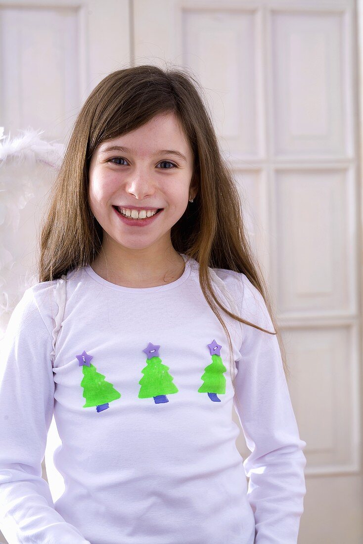 Girl wearing t-shirt with Christmas tree motifs