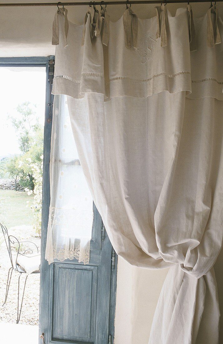 A curtain behind an open door