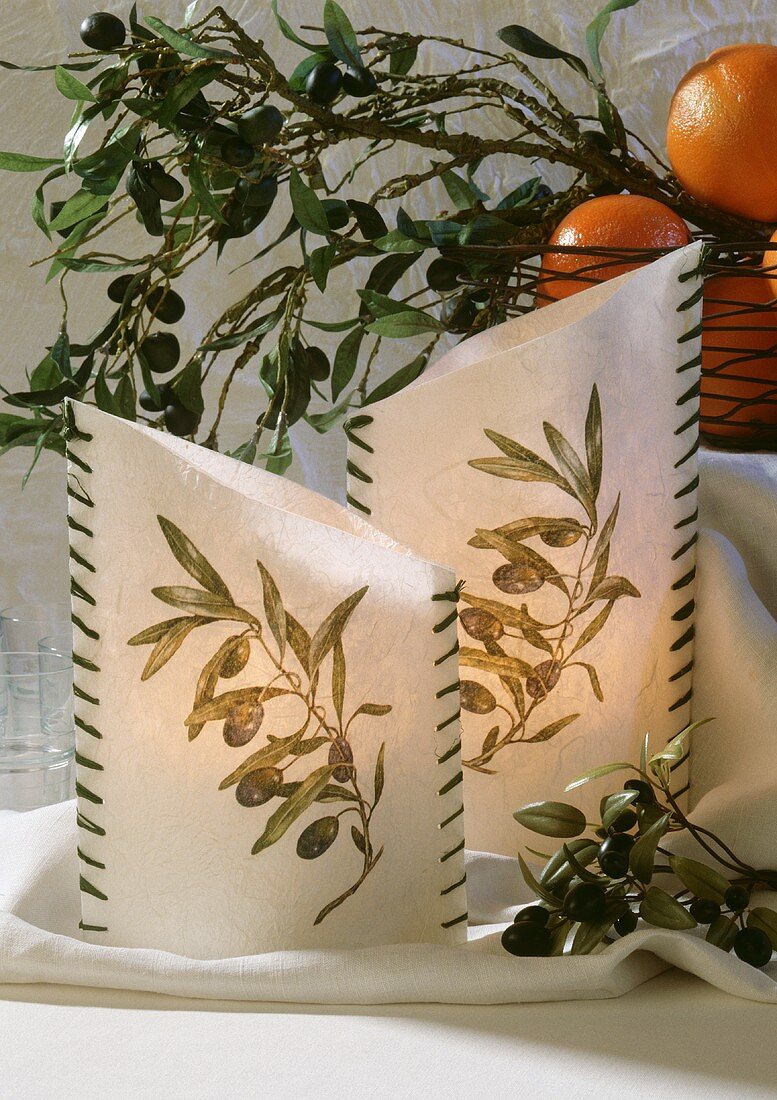 Windlicht mit Olivenzweigen dekoriert
