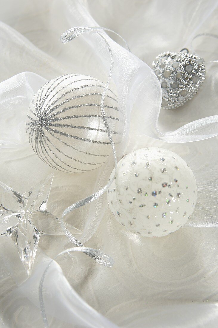White Christmas baubles, silver hanging heart and a glass star