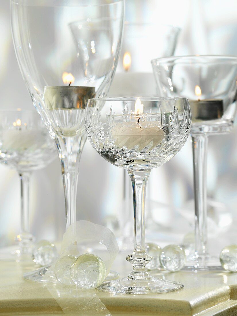 Tea lights in cut glass wine glasses