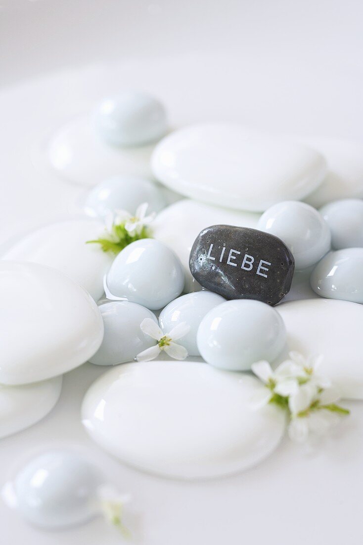 White stones and a grey stone with the word 'Liebe' (Love) written on it
