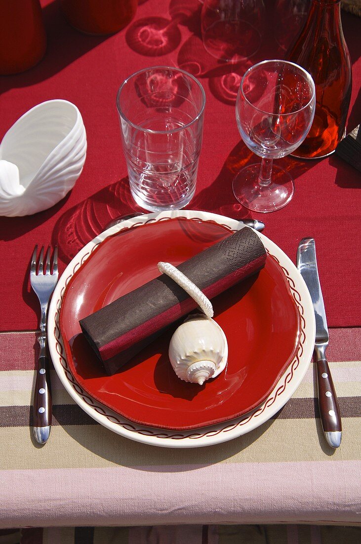 Table laid in red with maritime decorations