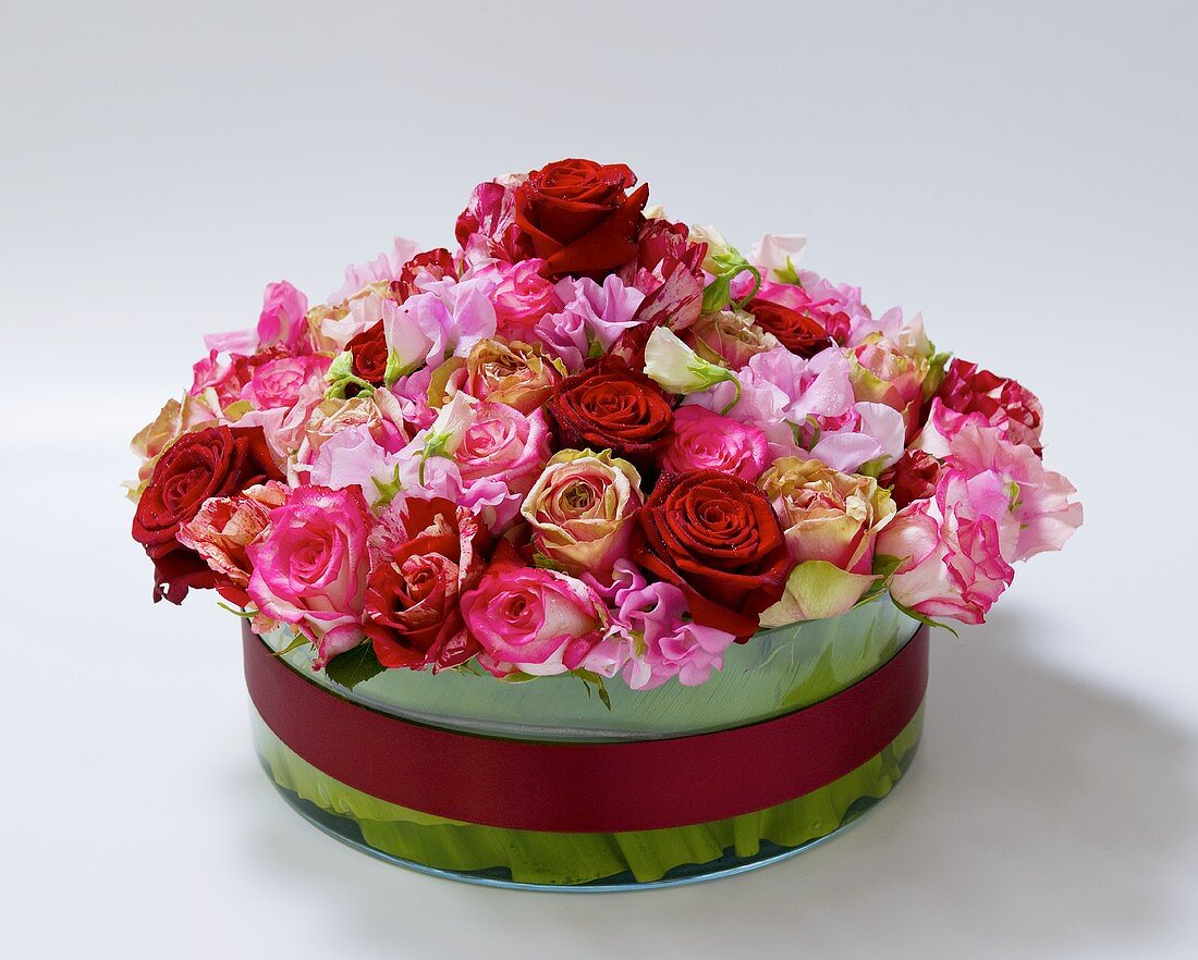 Arrangement of roses in round glass vase