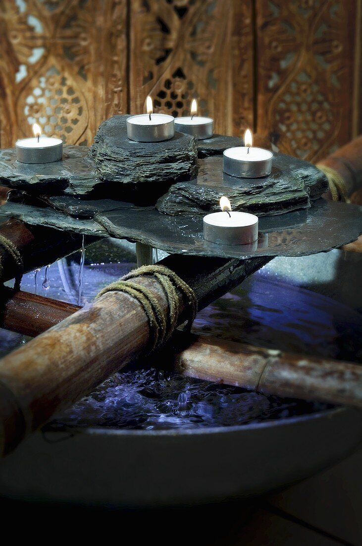 Rocks and tealights in spa (decoration)