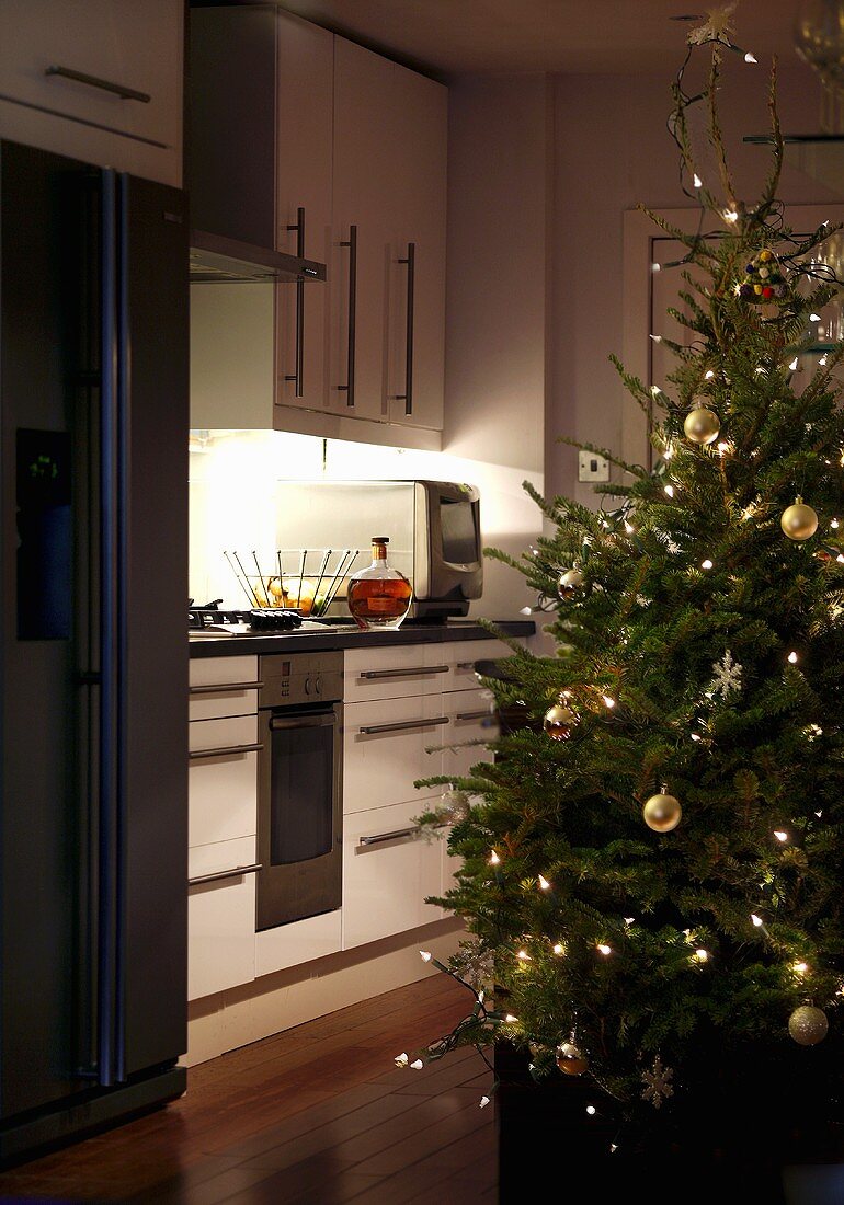 Decorated Christmas tree near a kitchen