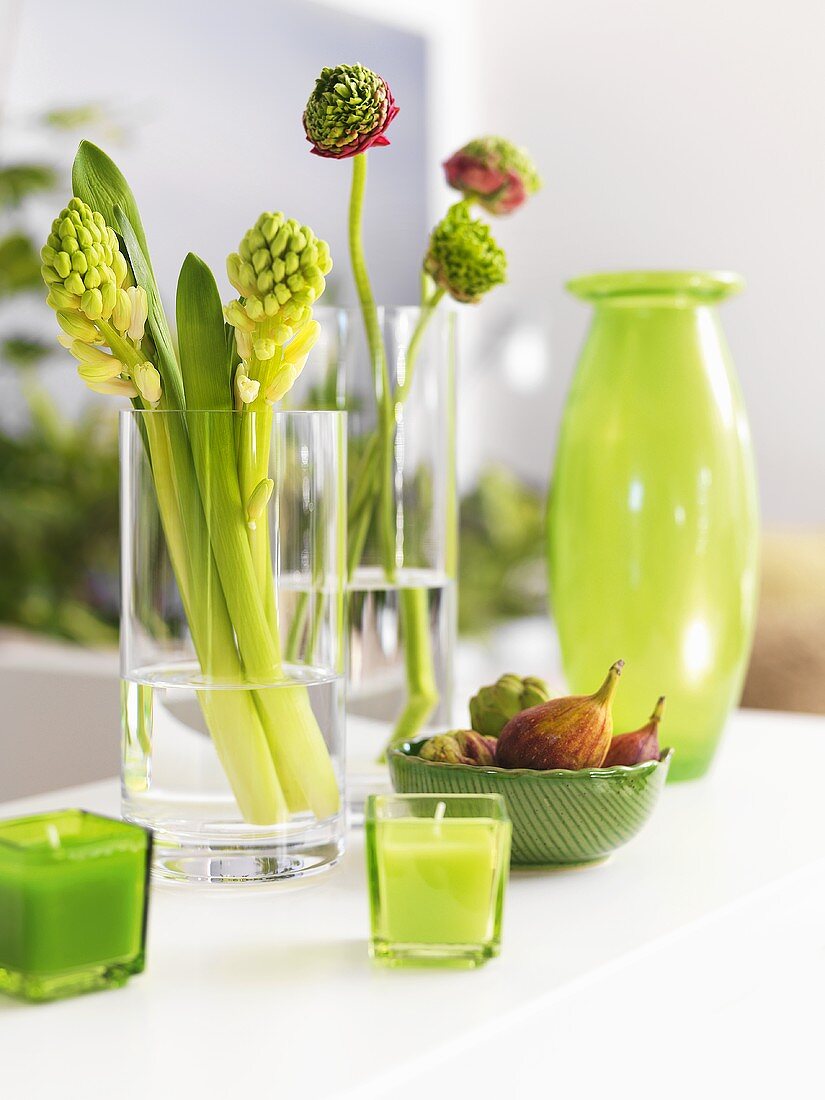 Spring decorations in pale green (flowers, candles, vase)